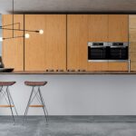 A sleek, minimalist Italian kitchen in a high-end setting.