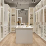 A wide shot of a luxury walk-in closet with an island and LED lighting.